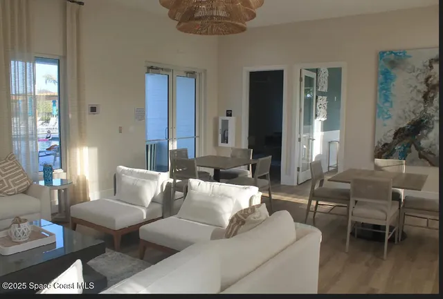 a living room with furniture and a large mirror