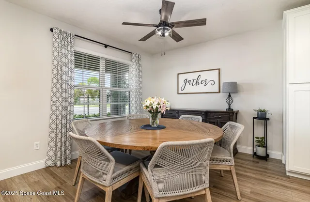 a dining room with furniture and window