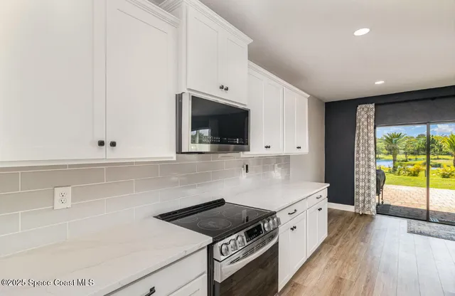a kitchen with a stove and a white cabinets