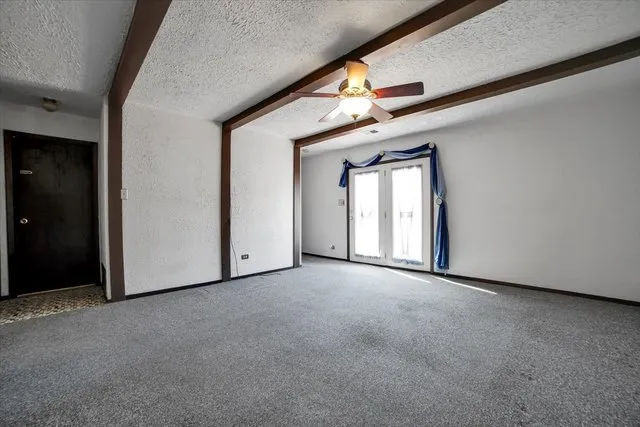 a view of a big room with windows and chandelier