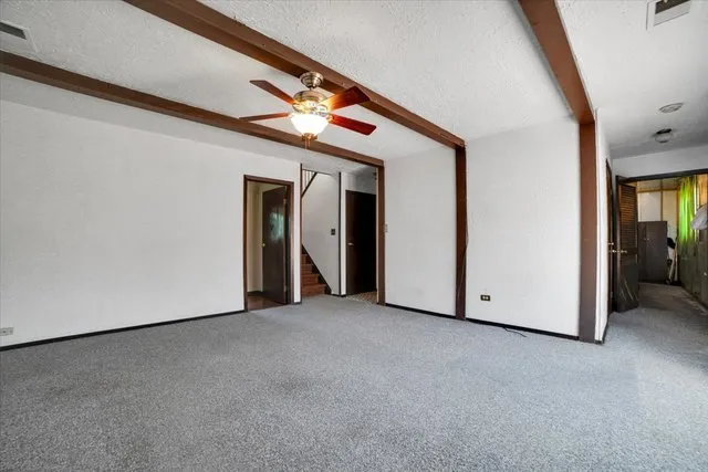 a view of an empty room with closet