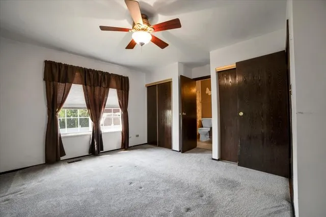 an empty room with windows and closet