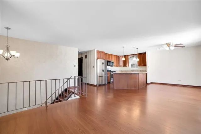 a view of a kitchen with furniture and wooden floor