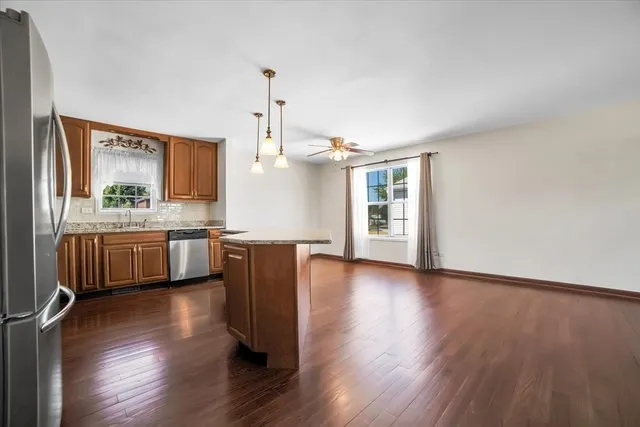 a kitchen with wooden floors and white walls