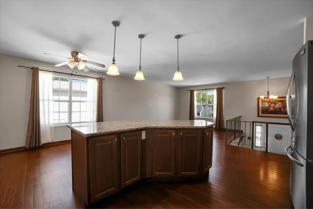 a kitchen with stainless steel appliances granite countertop wooden floors and sink