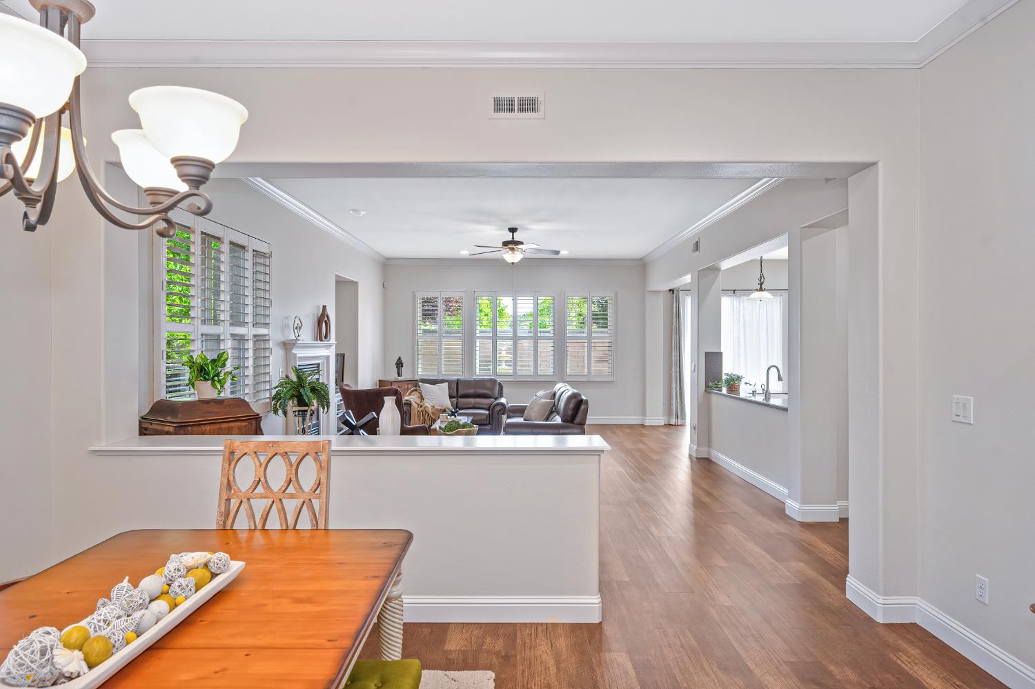 5966 Tanus Circle Rocklin, CA 95677 - Photo 13 of 38 a living room with kitchen island furniture and a chandelier