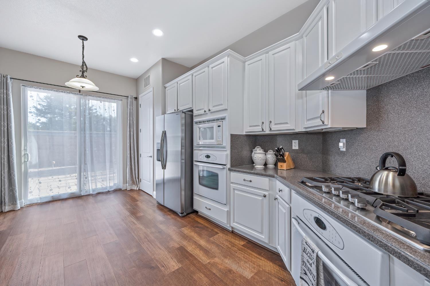 5966 Tanus Circle Rocklin, CA 95677 - Photo 21 of 38 a kitchen with white cabinets and appliances