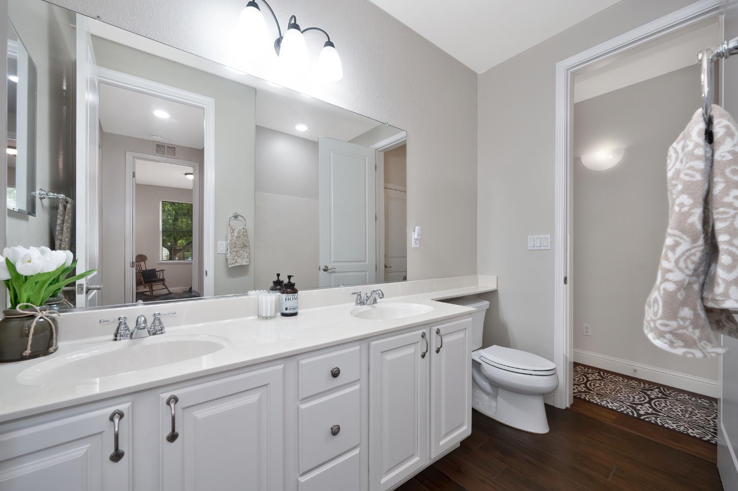 5966 Tanus Circle Rocklin, CA 95677 - Photo 24 of 38 a bathroom with a toilet sink and mirror