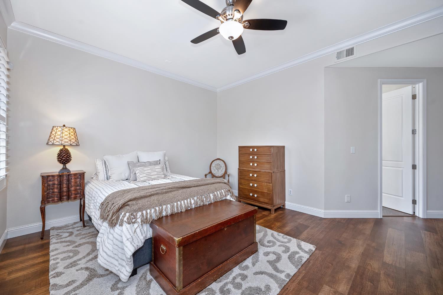 5966 Tanus Circle Rocklin, CA 95677 - Photo 28 of 38 a bedroom with a bed and wooden floor