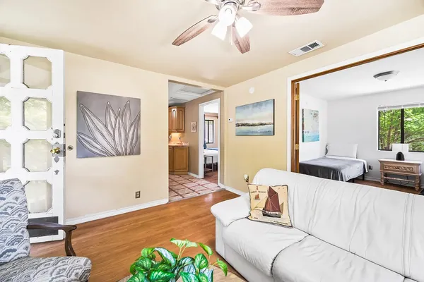 a living room with furniture and wooden floor