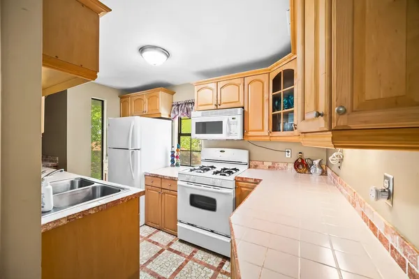 a kitchen with a sink a stove and a refrigerator