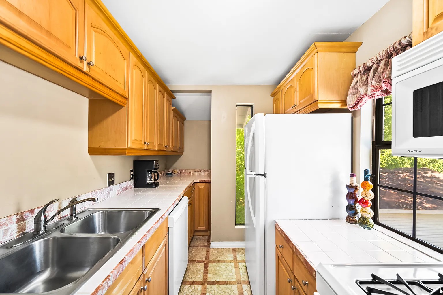 4812 Avenue G, Unit B Austin, TX 78751 - Photo 9 of 13 a kitchen with a sink a stove and a refrigerator