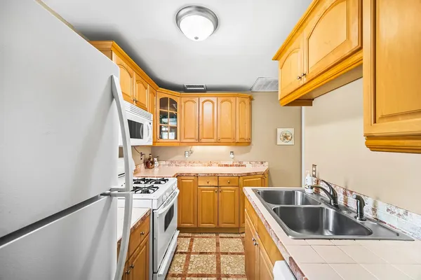 a kitchen with a stove a sink and a refrigerator