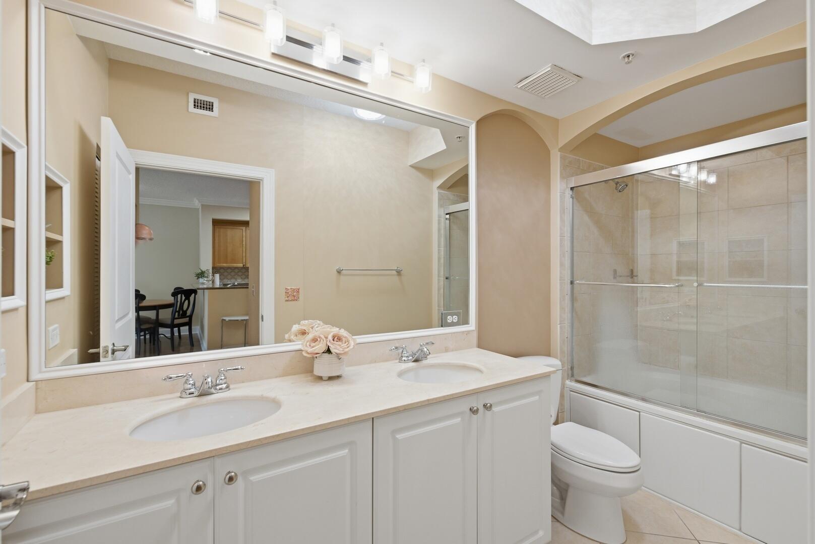 4 Renaissance Way, Unit 110 Boynton Beach, FL 33426 - Photo 3 of 26 a bathroom with a double vanity sink toilet and shower