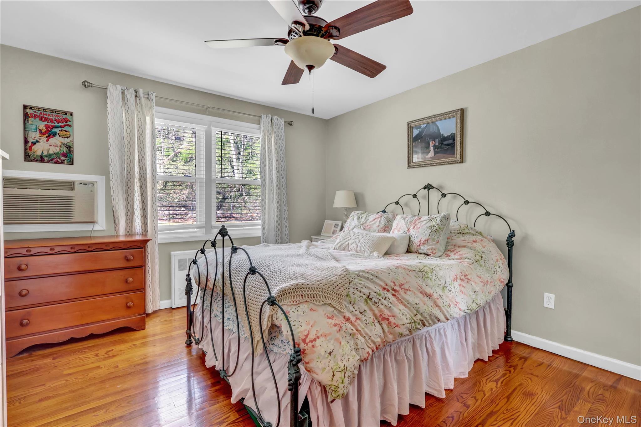 251-21 71st Road, Unit 44A Queens, NY 11426 - Photo 14 of 25 a bedroom with a bed and a dresser