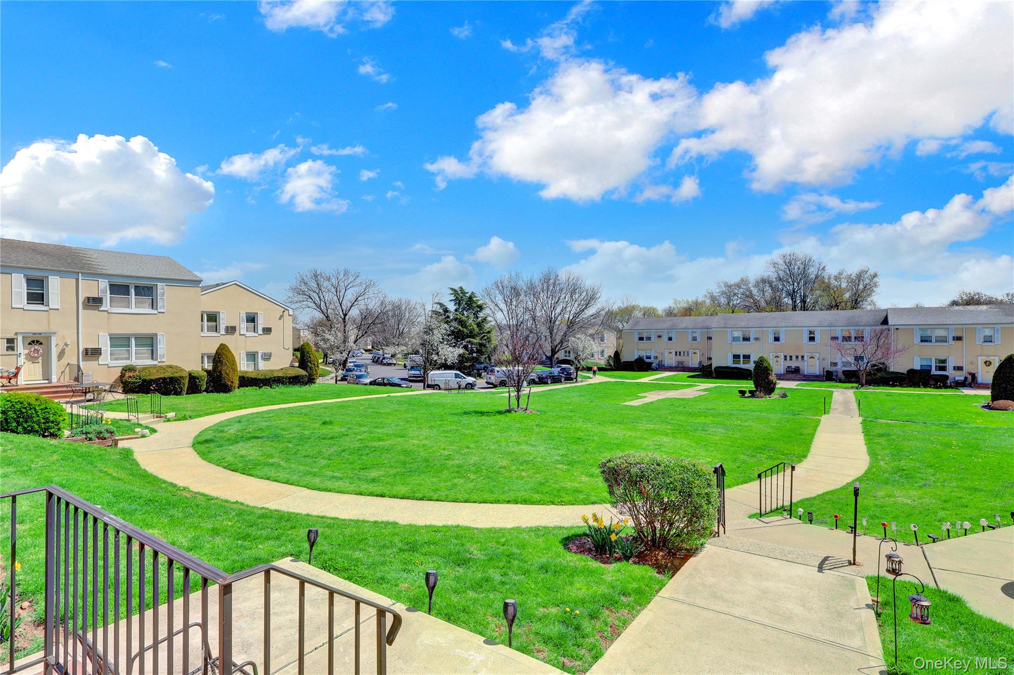 251-21 71st Road, Unit 44A Queens, NY 11426 - Photo 17 of 25 a view of building with garden