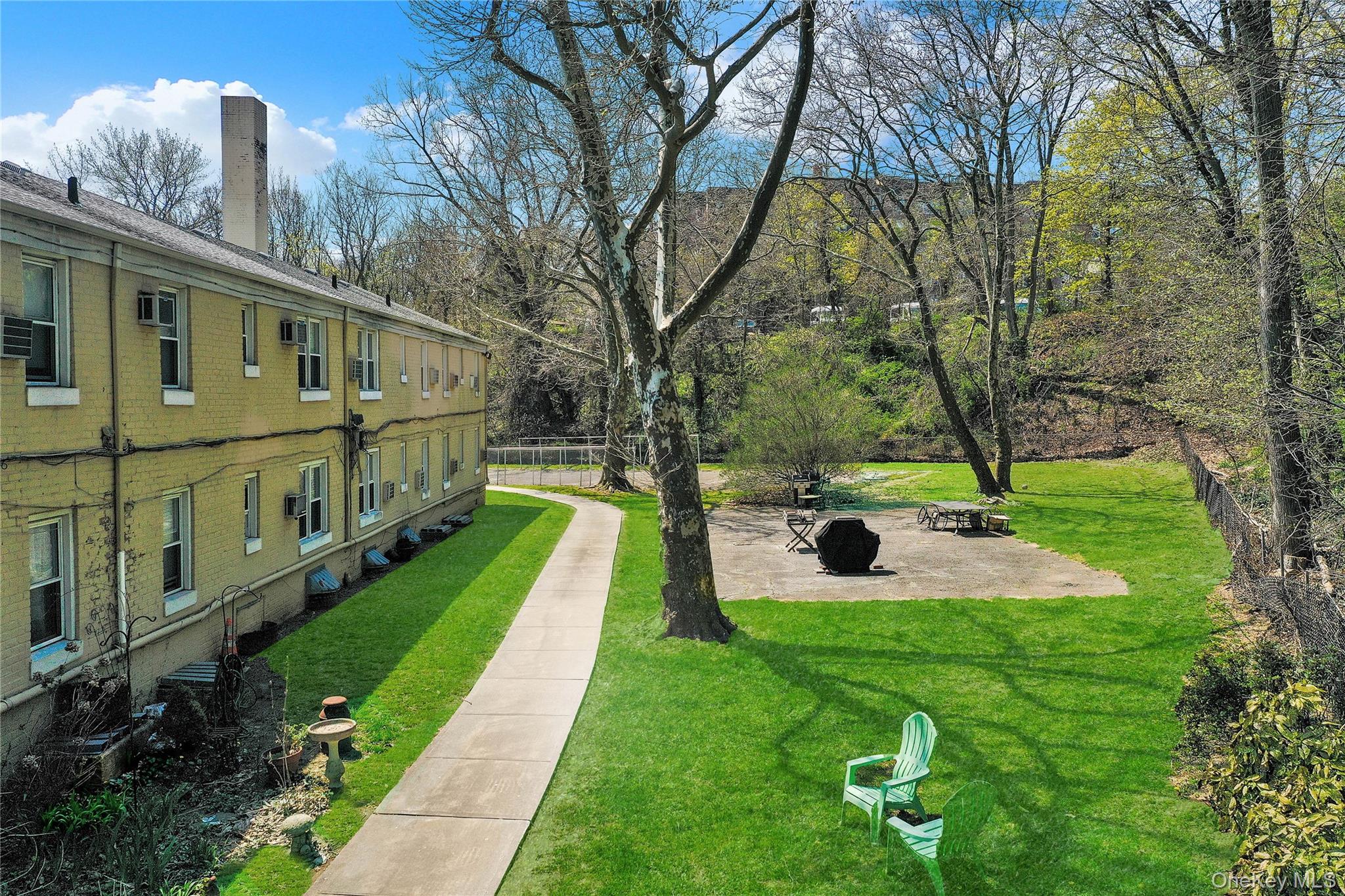 251-21 71st Road, Unit 44A Queens, NY 11426 - Photo 22 of 25 a view of an house with backyard and a tree