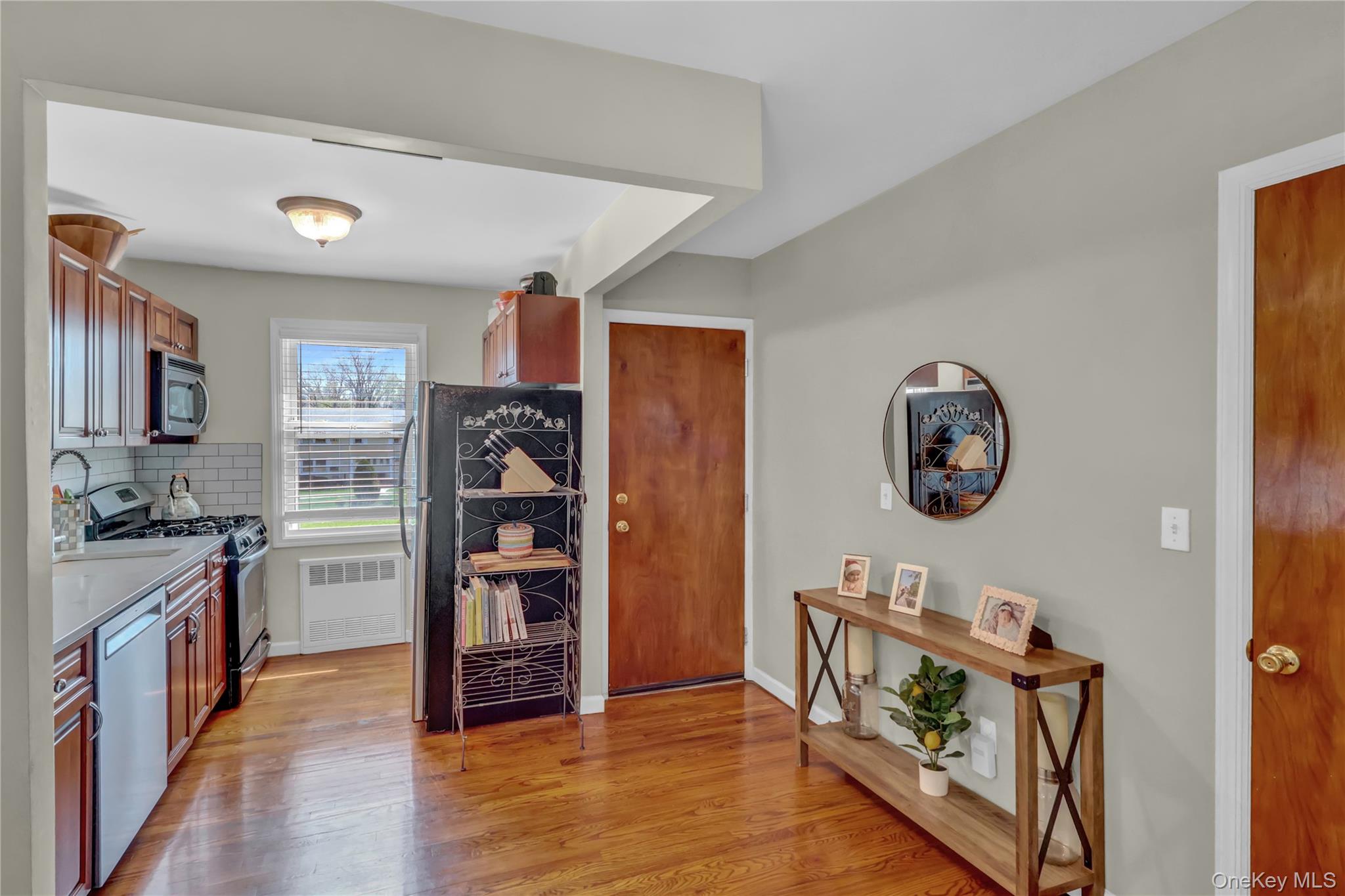 251-21 71st Road, Unit 44A Queens, NY 11426 - Photo 6 of 25 a kitchen with stainless steel appliances granite countertop a stove and a refrigerator