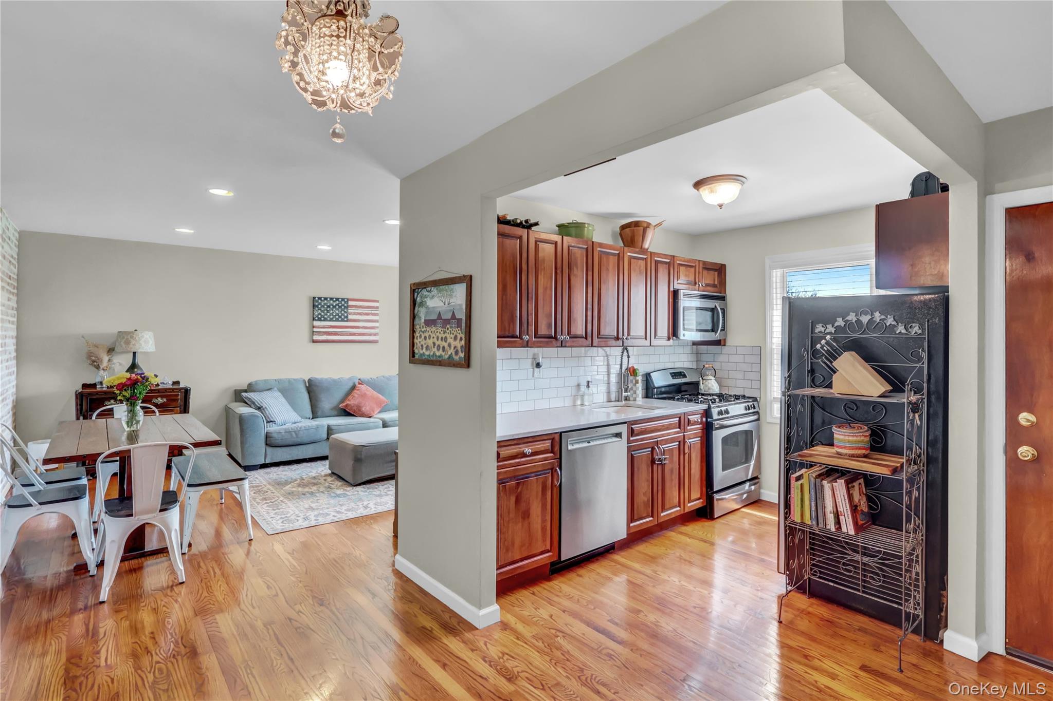 251-21 71st Road, Unit 44A Queens, NY 11426 - Photo 7 of 25 a open kitchen with stainless steel appliances granite countertop a stove and a wooden floors