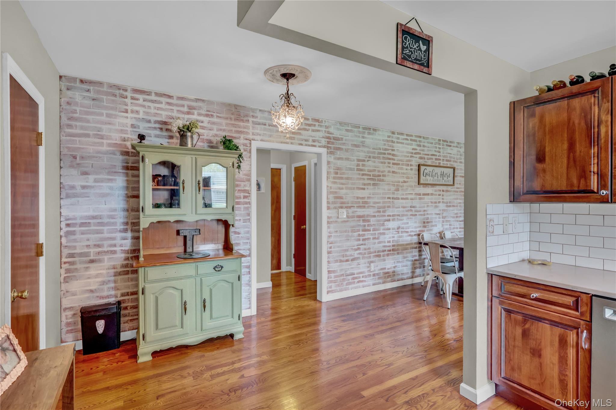 251-21 71st Road, Unit 44A Queens, NY 11426 - Photo 8 of 25 a hallway with fireplace and chandelier