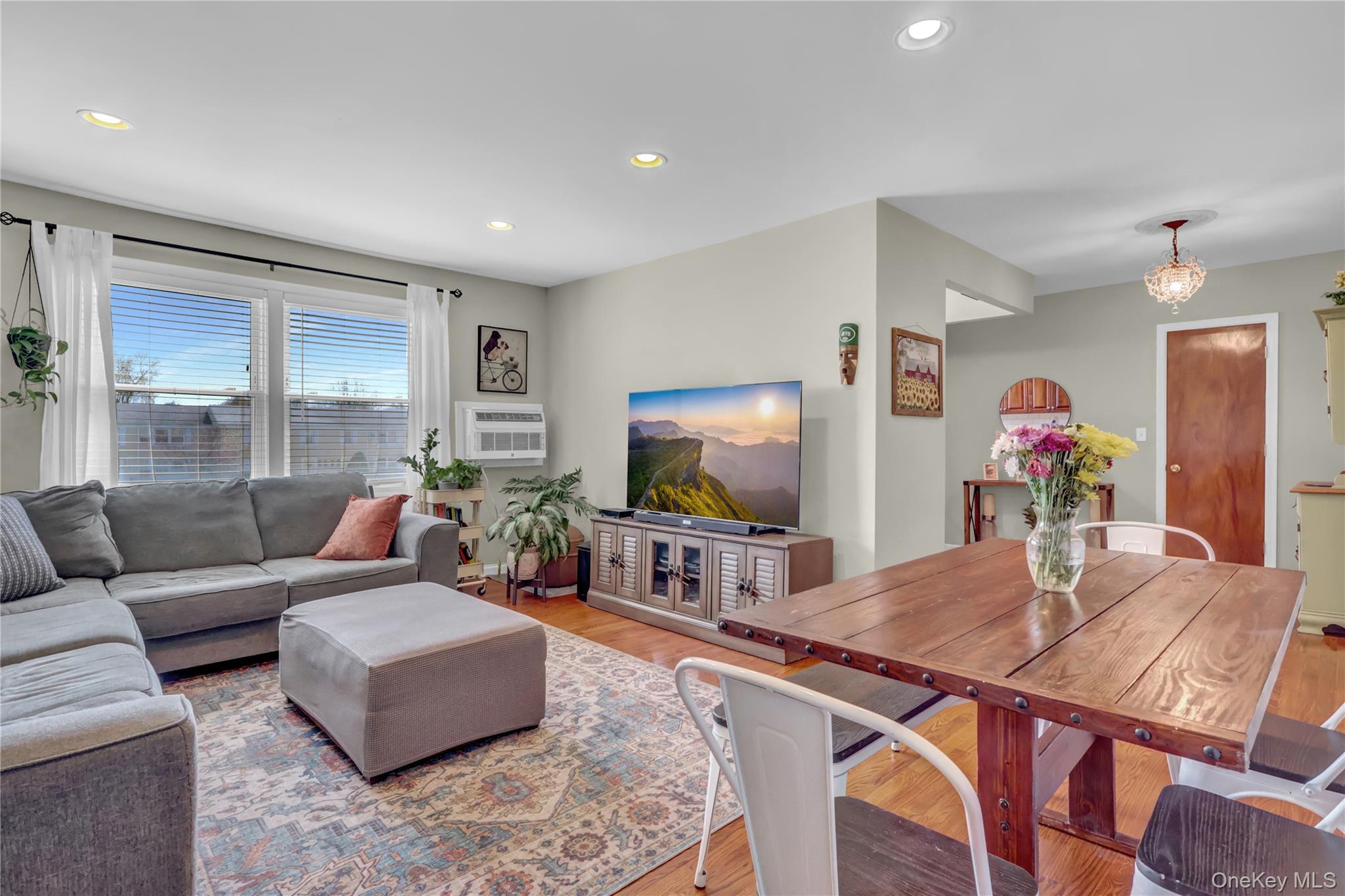 251-21 71st Road, Unit 44A Queens, NY 11426 - Photo 9 of 25 a living room with furniture and a flat screen tv