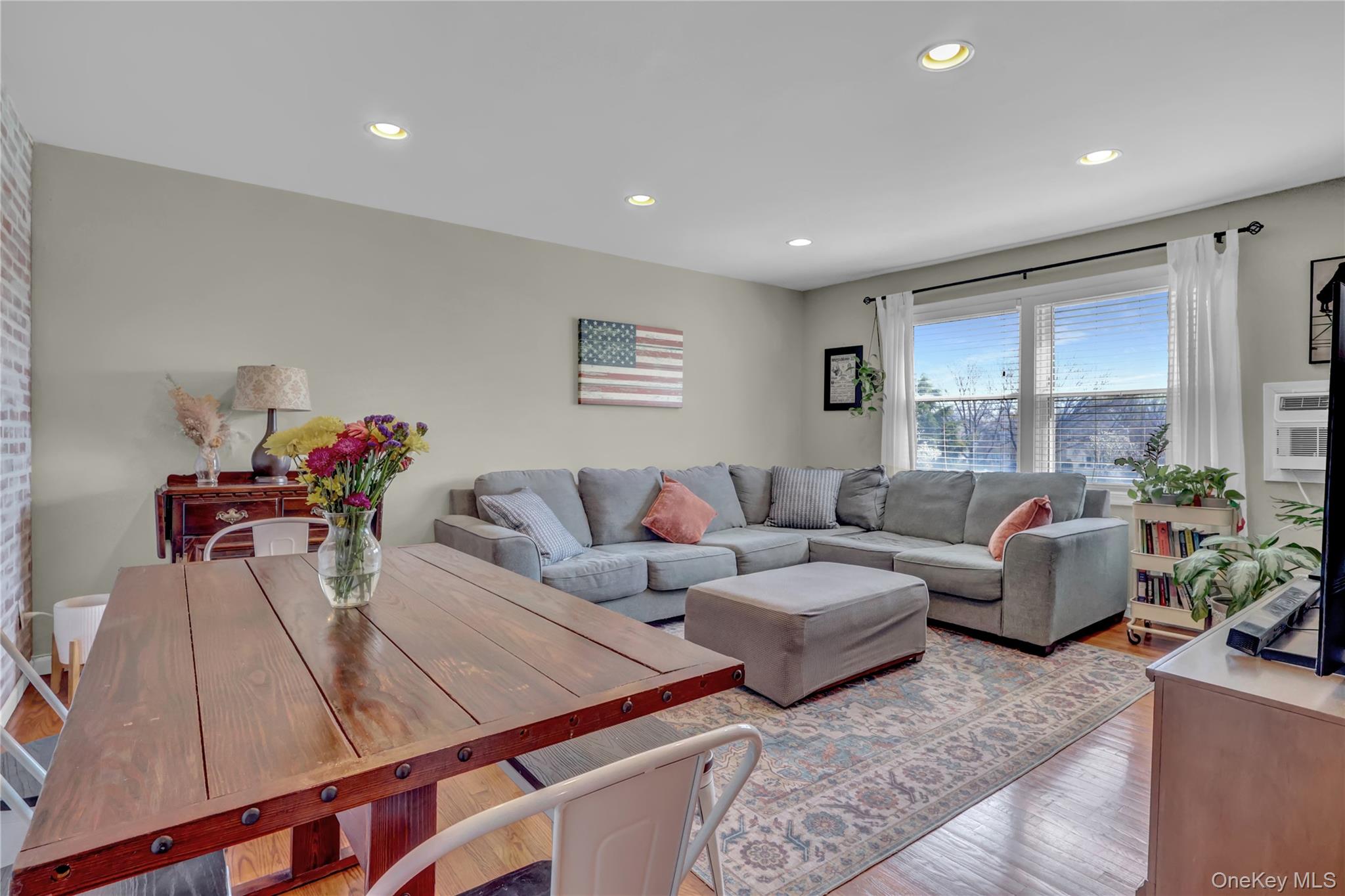 251-21 71st Road, Unit 44A Queens, NY 11426 - Photo 10 of 25 a living room with furniture and a large window