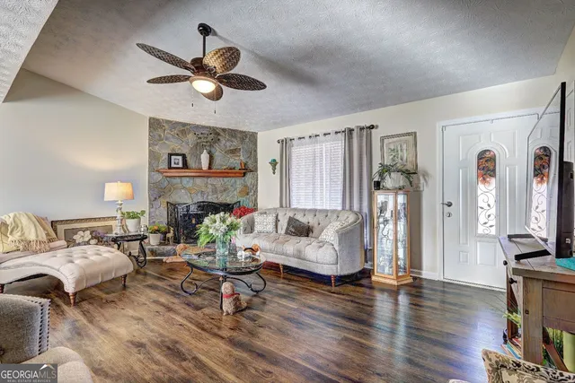 a living room with fireplace furniture and a wooden floor