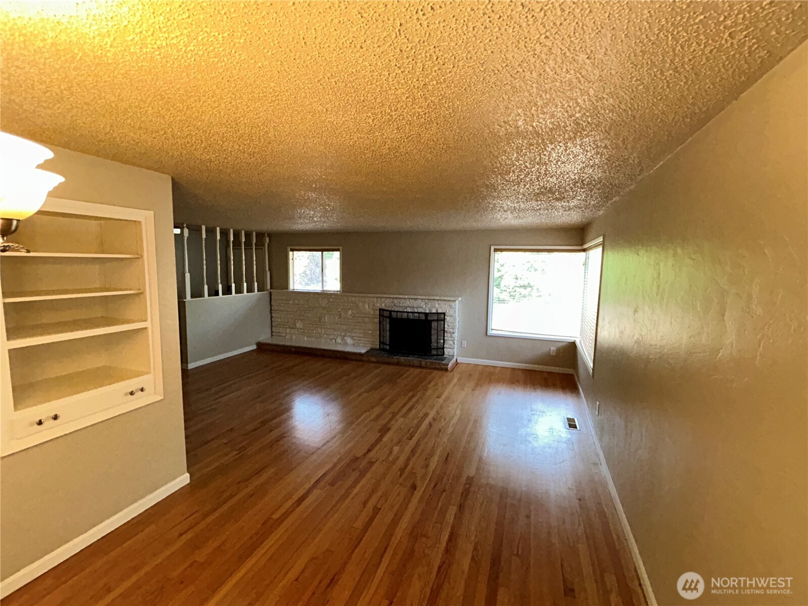6605 South 127th Place Seattle, WA 98178 - Photo 12 of 38 a view of empty room with wooden floor and fan