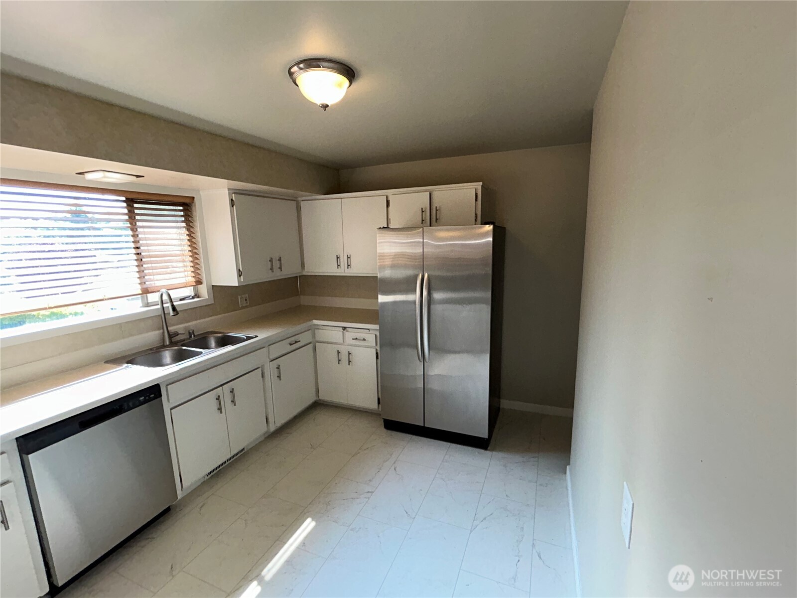 6605 South 127th Place Seattle, WA 98178 - Photo 13 of 38 a kitchen with a refrigerator sink and cabinets