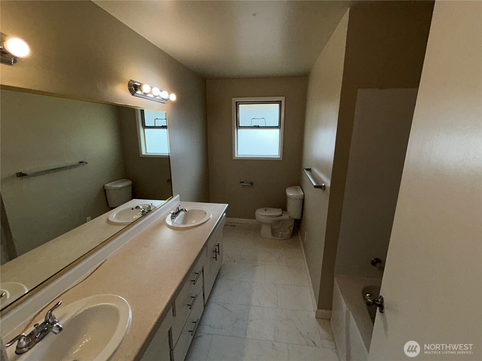 6605 South 127th Place Seattle, WA 98178 - Photo 16 of 38 a bathroom with a sink a toilet and mirror