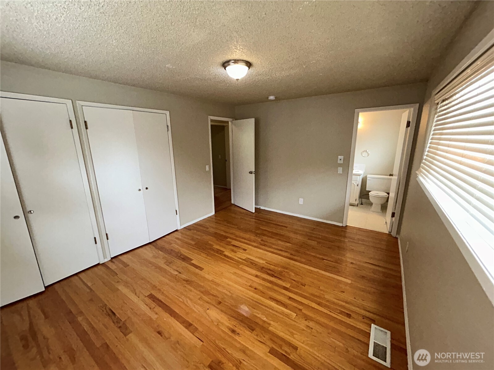 6605 South 127th Place Seattle, WA 98178 - Photo 22 of 38 a view of empty room with wooden floor