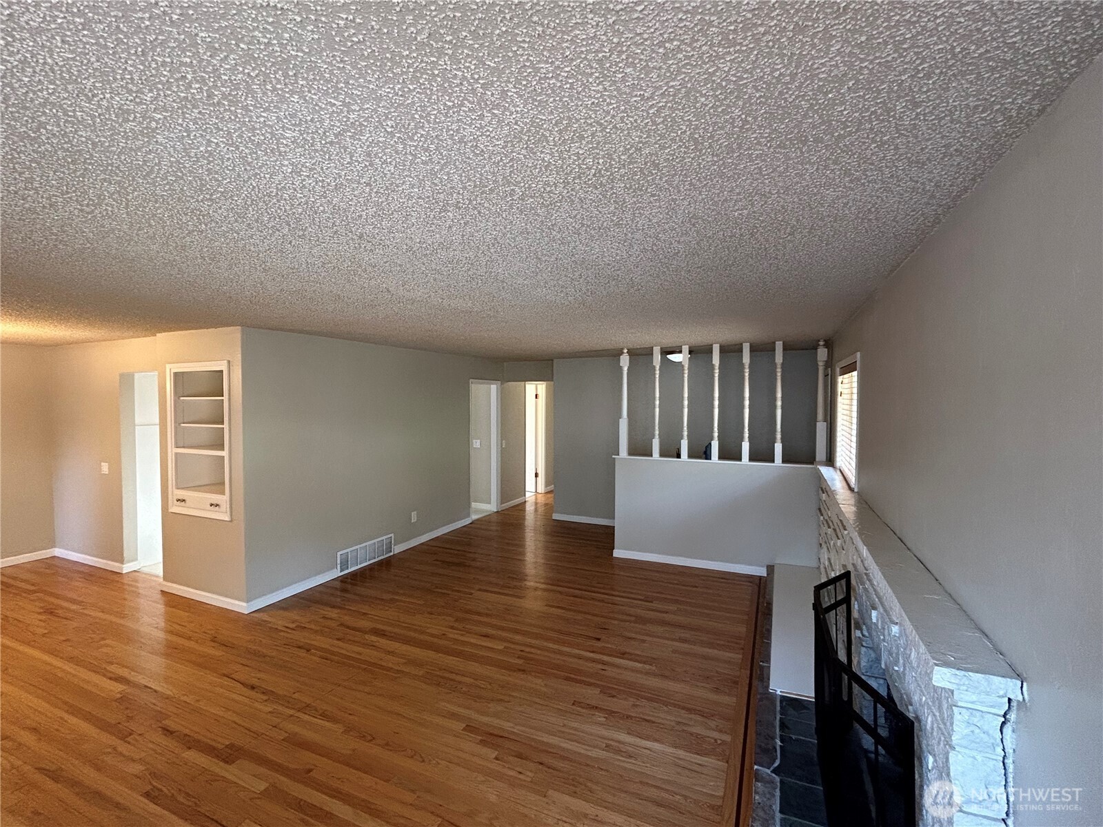 6605 South 127th Place Seattle, WA 98178 - Photo 5 of 38 a view of an empty room with wooden floor and a window