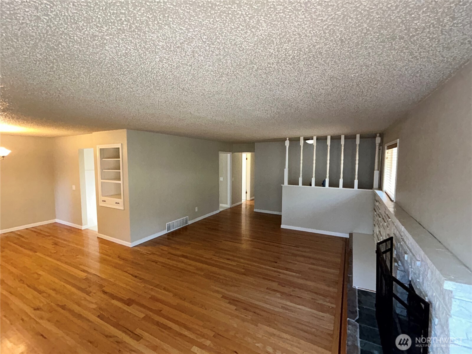 6605 South 127th Place Seattle, WA 98178 - Photo 8 of 38 a view of an empty room with wooden floor and a window