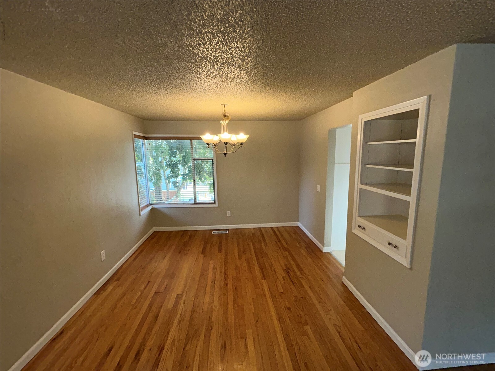 6605 South 127th Place Seattle, WA 98178 - Photo 9 of 38 wooden floor in an empty room with a window