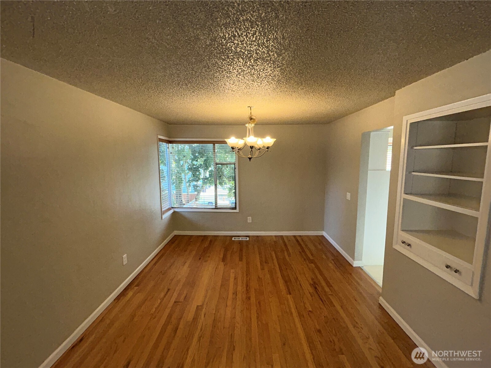 6605 South 127th Place Seattle, WA 98178 - Photo 10 of 38 wooden floor in an empty room with a window