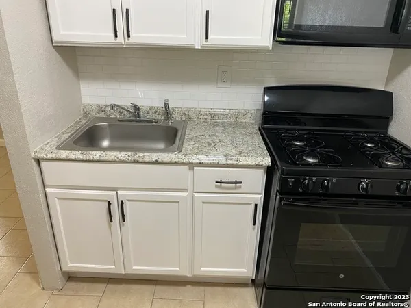 a kitchen with a sink and cabinets