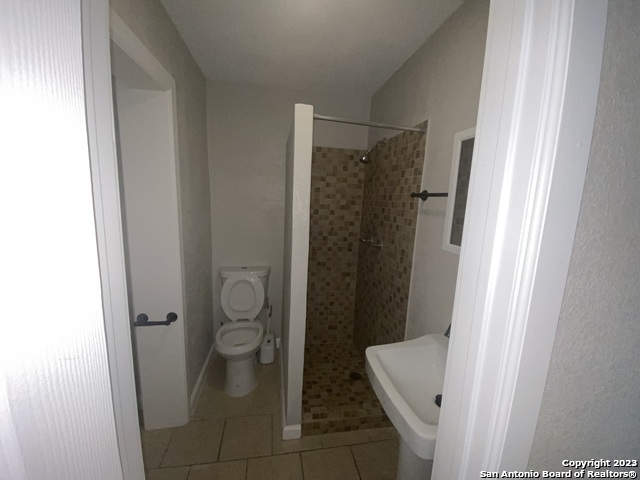 115 Caldwell Street, Unit 3 San Antonio, TX 78223 - Photo 5 of 5 a bathroom with a granite countertop toilet and a shower