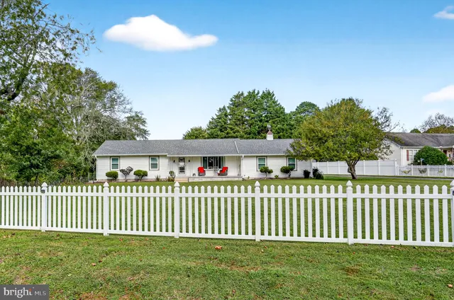 a front view of a house having a garden