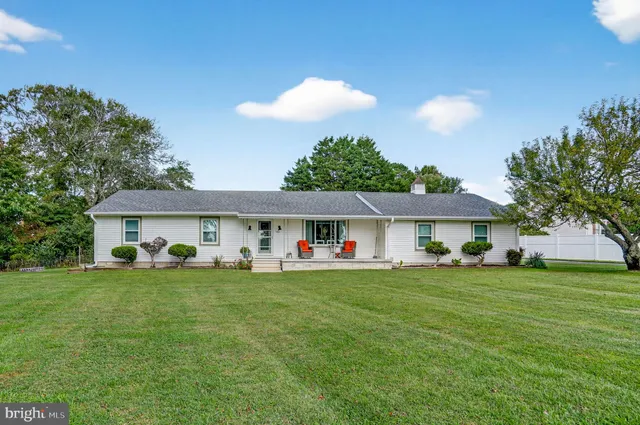 a view of a house with a yard and sitting area