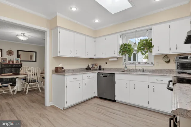 a living room with furniture a flat screen tv and a table