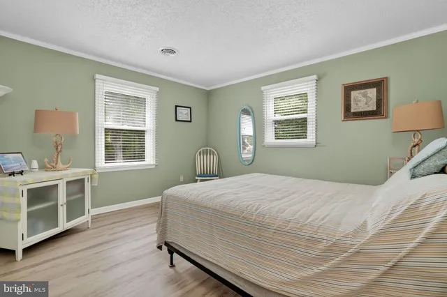 a bedroom with a large bed and a ceiling fan