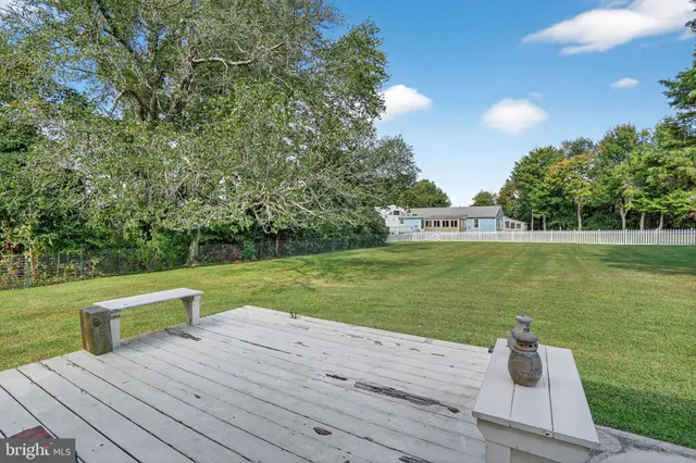 a front view of a house with a yard table and chairs