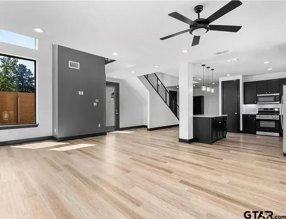 a view of a kitchen with a microwave and a ceiling fan