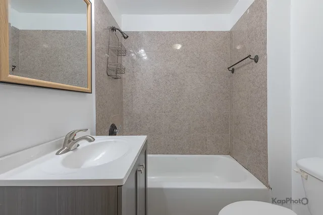 a bathroom with a sink toilet and shower