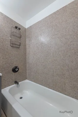 a bathroom with a white bath tub and a sink
