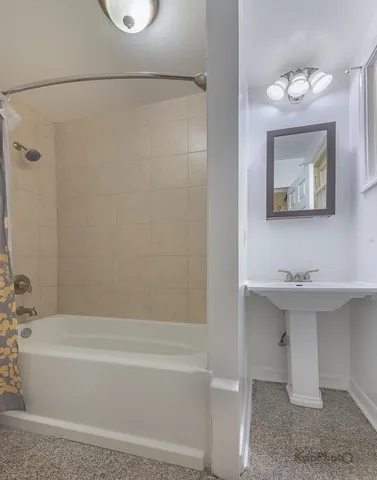 a bathroom with a sink a mirror and a bathtub