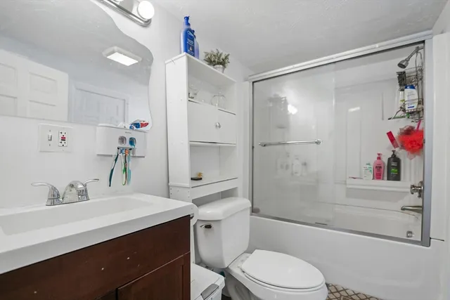 a bathroom with a sink vanity mirror and toilet