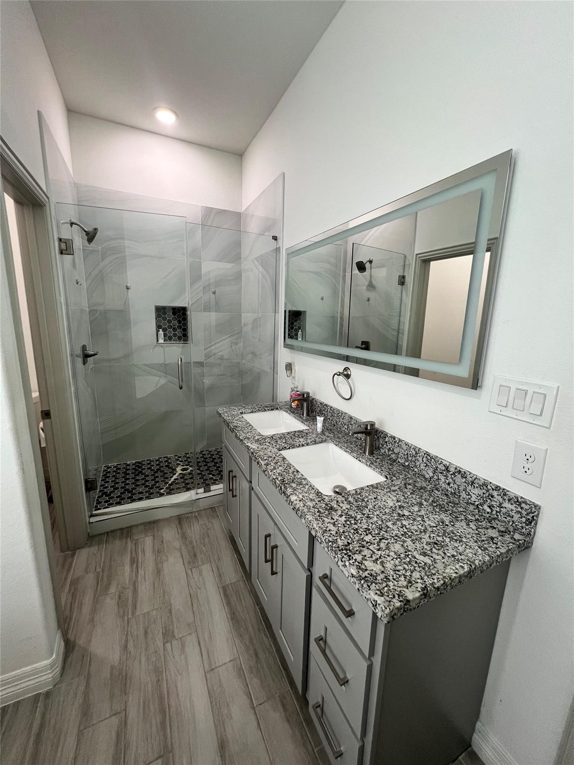 3407 Sakowitz Street, Unit B Houston, TX 77026 - Photo 7 of 23 a bathroom with a granite countertop sink a mirror and shower