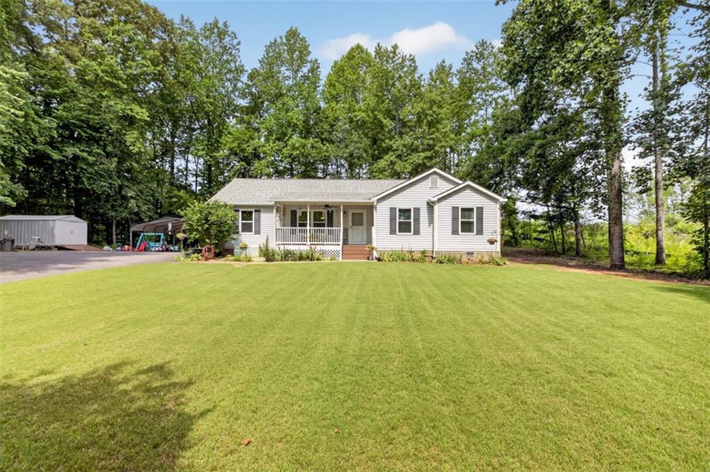 3771 Castleberry Road Cumming, GA 30040 - Photo 6 of 69 a front view of a house with yard and green space