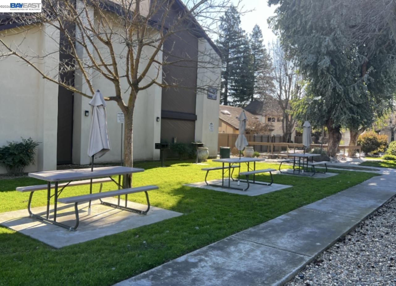 3701 Colonial Drive, Unit 36 Modesto, CA 95356 - Photo 29 of 36 a view of a swimming pool with a bench and trees in the background